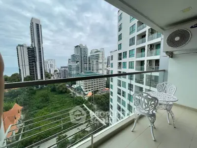 Stunning high-rise balcony with cityscape view and elegant outdoor seating.
