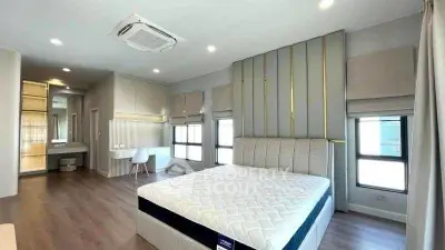Spacious modern bedroom with elegant decor and ample natural light