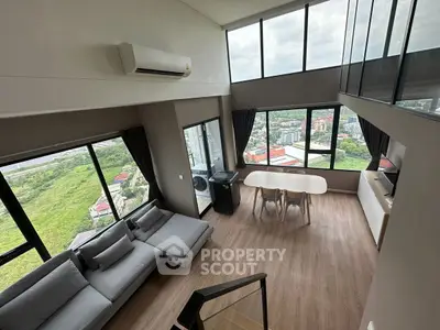 Stunning high-rise living room with panoramic city views and modern furnishings.