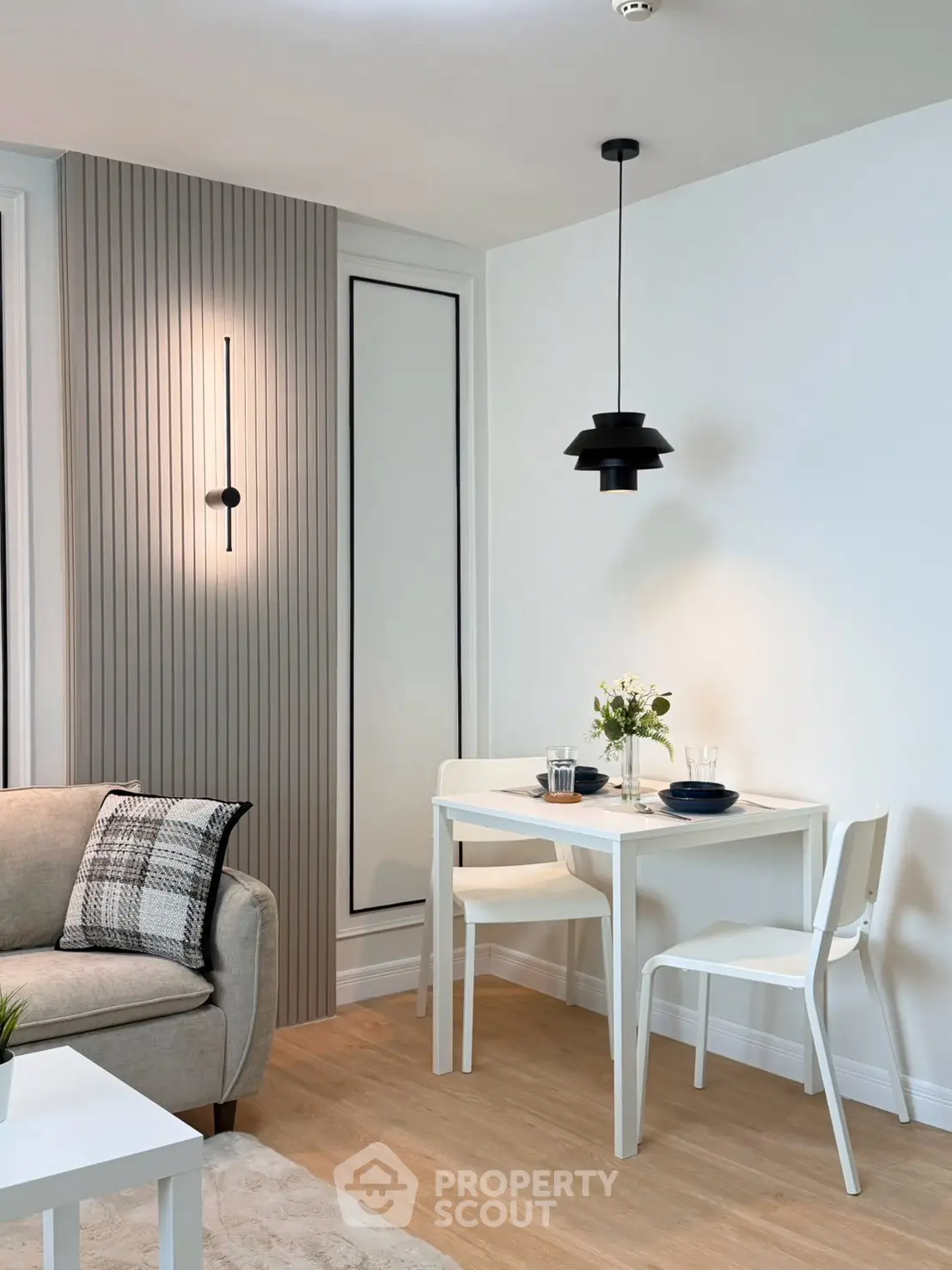 Modern living room with stylish dining area and elegant lighting