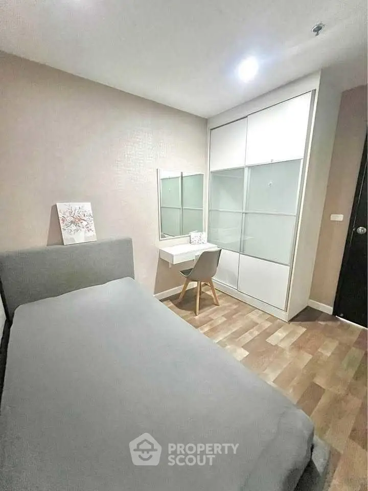 Cozy bedroom with modern furniture and ample storage space.