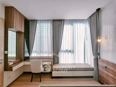 Modern study room with elegant wooden furniture and large windows with sheer curtains.