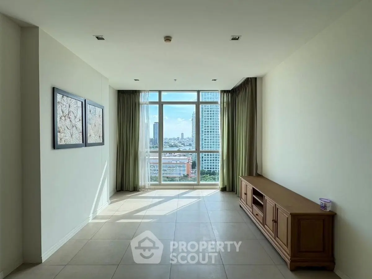 Spacious living room with large window offering stunning city views, perfect for modern urban living.