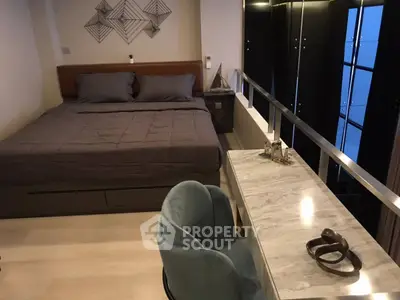 Stylish modern bedroom with elegant decor and cozy workspace in a contemporary apartment.