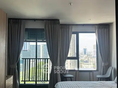 Modern bedroom with city view and large windows in high-rise apartment