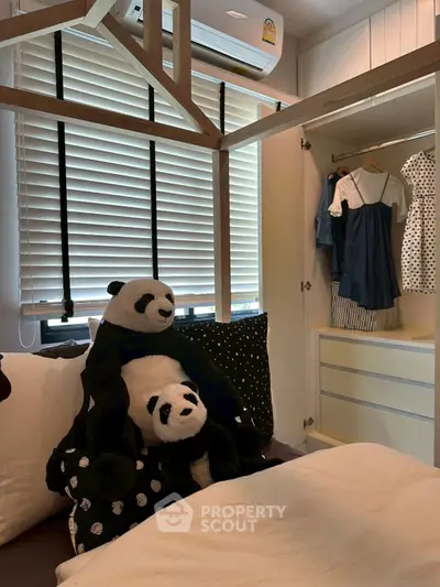 Charming bedroom with cozy decor and plush panda toys, featuring a stylish open wardrobe.