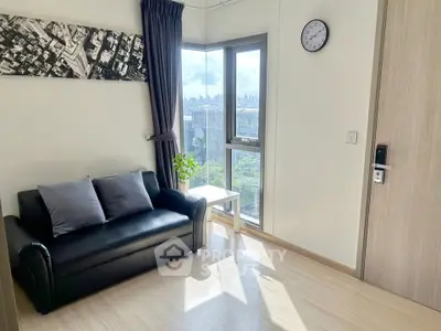 Bright living room with city view, modern decor, and cozy seating area.