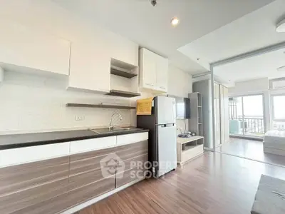Modern open-layout kitchen and living area with sleek design and natural light