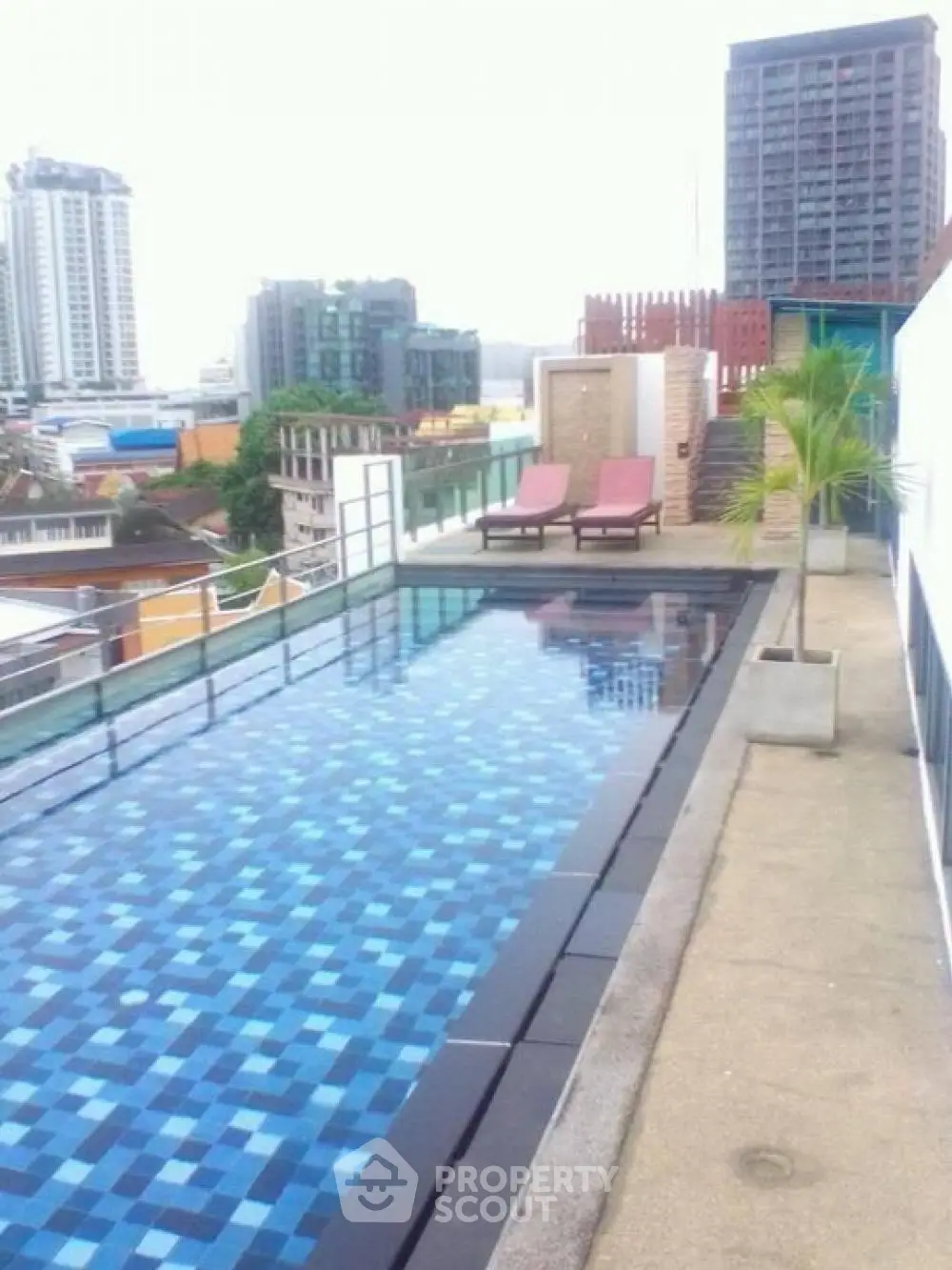 Luxurious rooftop infinity pool with panoramic city views, offering a serene escape amidst the urban landscape, perfect for relaxation and entertainment.