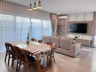 Spacious modern living room with elegant dining area and large windows.