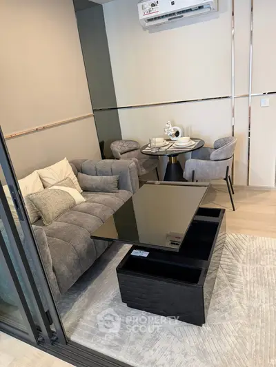 Modern living room with sleek furniture and dining area, featuring a convertible coffee table and stylish decor.