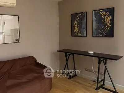 Stylish living room with modern art and sleek furniture, perfect for contemporary living.