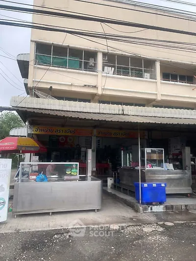 Commercial property with street-facing storefront and ample signage, ideal for retail or restaurant business.