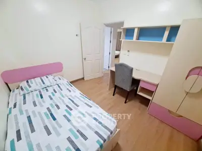 Cozy bedroom with modern furniture and study desk, perfect for comfortable living.
