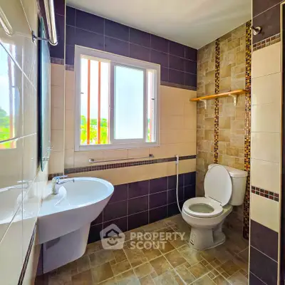 Modern bathroom with stylish tiles and natural light from window