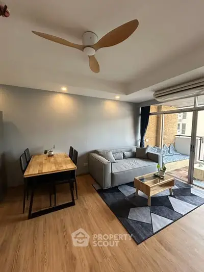 Modern living room with stylish furniture and balcony access