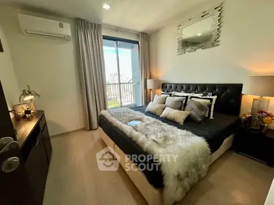 Luxurious bedroom with elegant decor and balcony view in modern apartment.