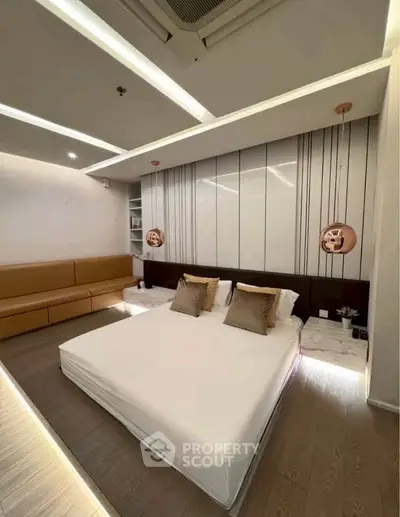 Modern bedroom with stylish lighting and cozy seating area