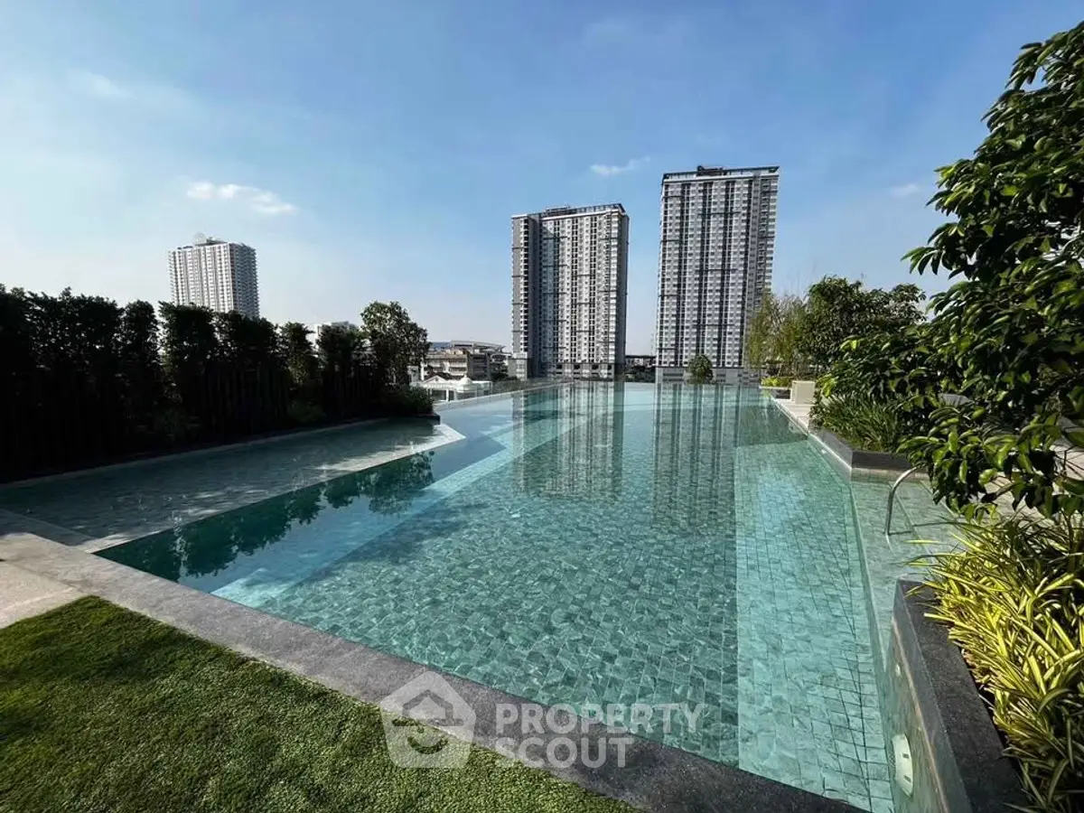 Luxurious infinity pool with stunning cityscape view and lush greenery