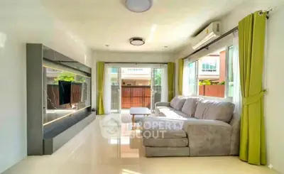 Spacious living room with modern decor and large windows offering natural light.