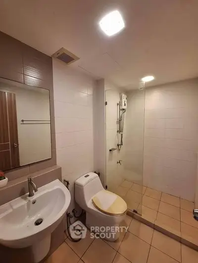 Modern bathroom with glass shower and sleek fixtures in a contemporary home.