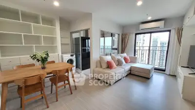 Modern living room with open layout, cozy sofa, dining area, and balcony view in a stylish apartment.