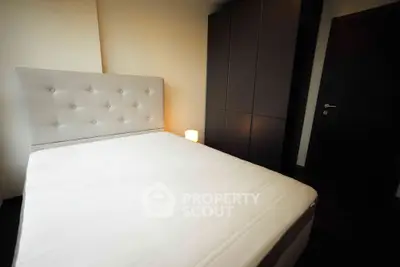 Cozy bedroom with modern wardrobe and soft lighting, perfect for relaxation.