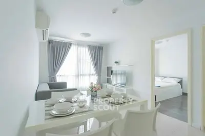 Modern open-plan living room with dining area and natural light
