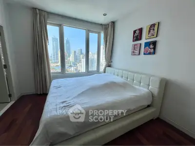 Spacious bedroom with city view and elegant decor in modern apartment