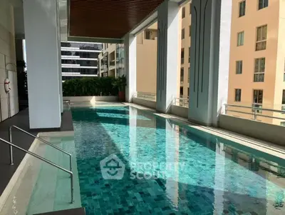 Luxurious rooftop pool with stunning city views in modern high-rise building.