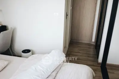 Cozy bedroom with modern decor and wooden flooring, perfect for relaxation.