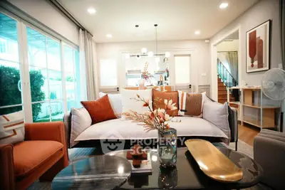 Stylish living room with modern decor and large windows offering natural light.