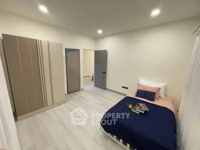 Cozy bedroom with modern decor and ample lighting