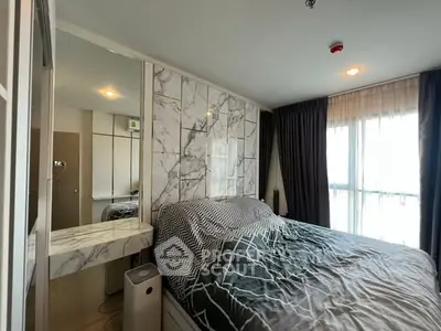 Modern bedroom with marble accents and large window offering natural light.