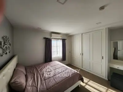 Spacious bedroom with natural light and modern decor