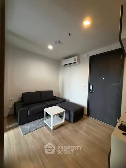 Modern living room with sleek black sofa and minimalist decor