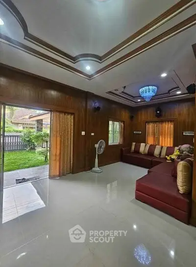 Spacious living room with elegant ceiling design and garden view, perfect for family gatherings.