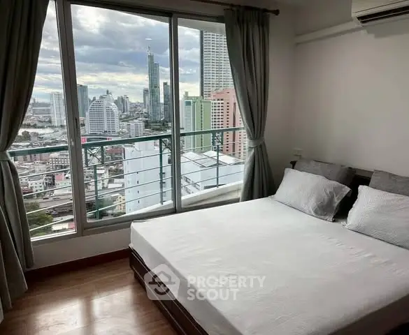 Modern bedroom with city view, featuring large windows and stylish decor.