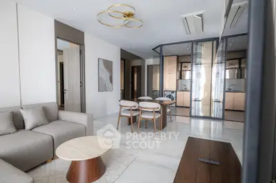 Modern open-plan living room with elegant furniture and stylish kitchen area