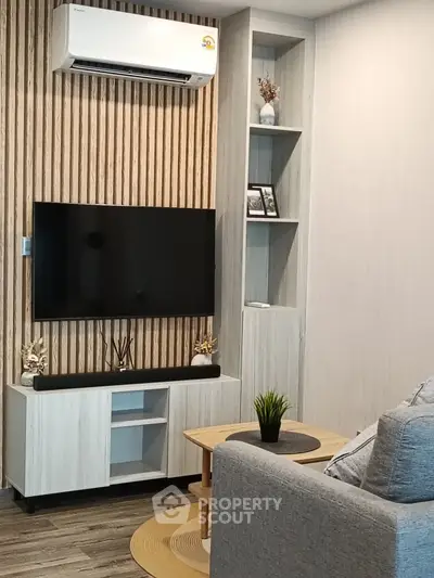 Modern living room with wall-mounted TV and air conditioning unit, stylish decor
