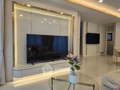 Luxurious modern living room with sleek TV setup and elegant decor