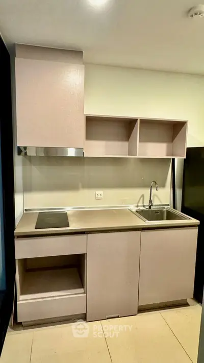 Modern minimalist kitchen with sleek cabinetry and built-in sink