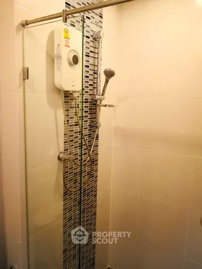 Modern bathroom shower area with sleek design and water heater