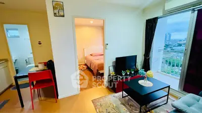 Modern apartment with cozy living room and bedroom, featuring city view and stylish decor.