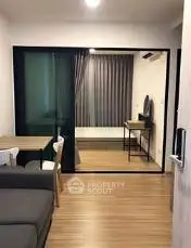 Modern living room with glass partition and wooden flooring