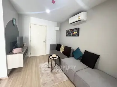 Modern living room with sleek furniture and air conditioning in a stylish apartment.