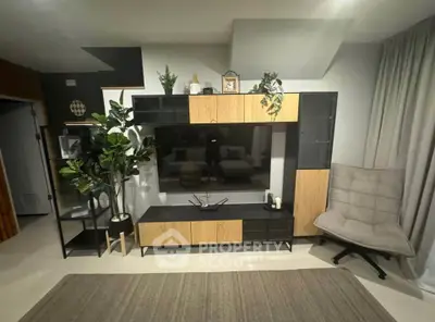 Modern living room with stylish entertainment unit and cozy chair