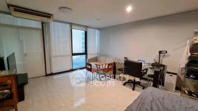 Spacious living room with modern furniture and large windows offering natural light.