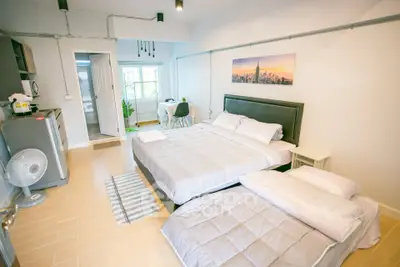 Spacious bedroom with modern decor and natural light