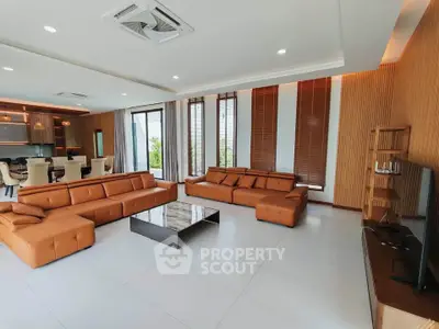 Spacious modern living room with stylish furniture and open kitchen layout